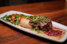Cafe Sevilla signature dishes Rioja Short RibValenciana PaellaCheese & Chorizo Empanada Duo